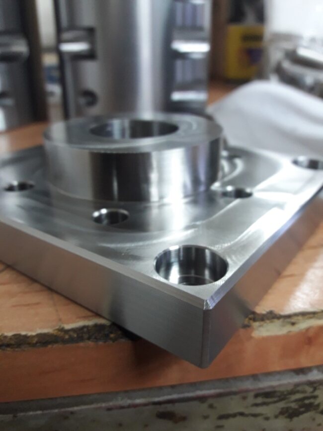 Precisely machined metal part with drilled holes